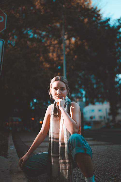 Free Woman Sitting Near the Sidewalk Stock Photo