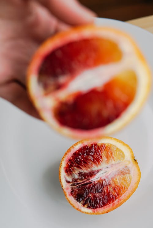 Person Holding Sliced Fruit