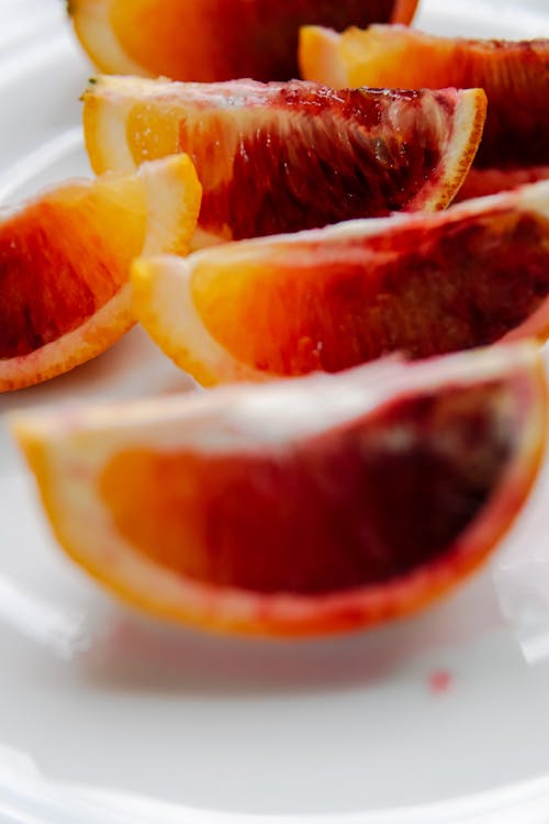 Sliced Orange Fruit on White Ceramic Plate