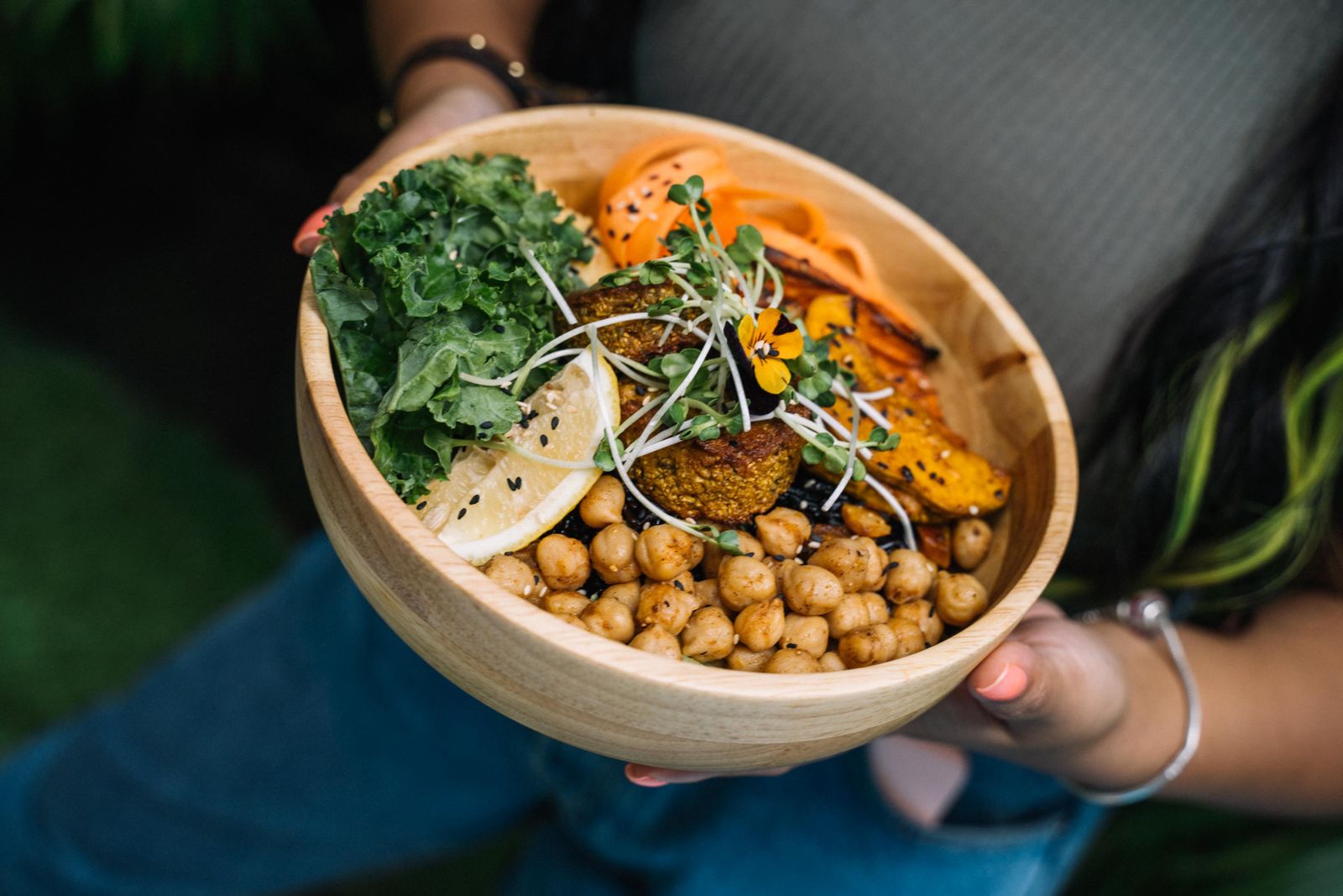 Healthy vegan bowl with chickpeas, kale, carrots and lemon representing a sattvic diet for weight loss