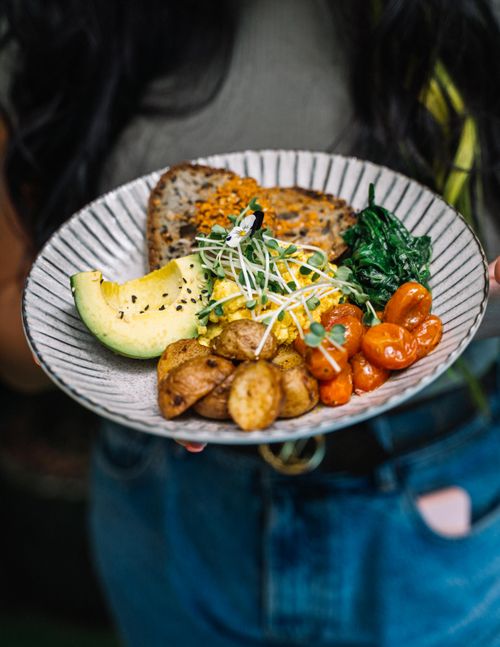 Free A colorful plate of avocado, potatoes, tomatoes, greens, and bread for a nutritious meal. Stock Photo