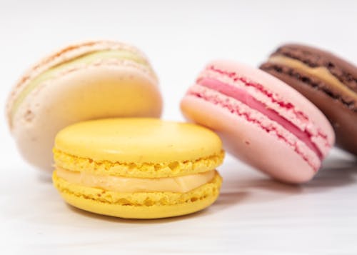 Multi colored macaroons on white table