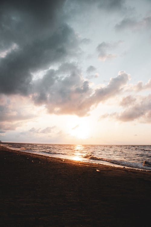 Sea Waves Crashing on Shore during Sunset