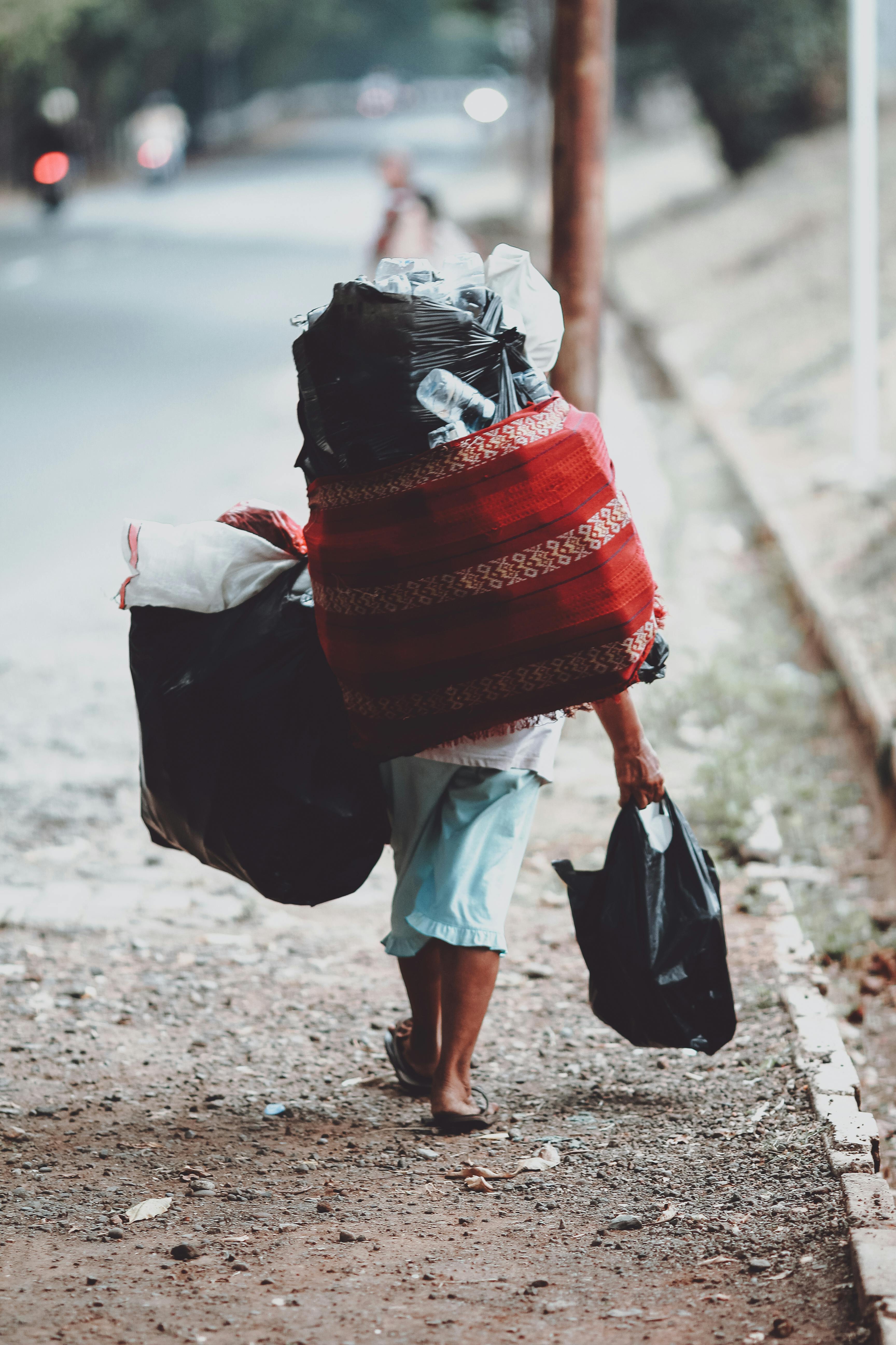 person carrying bags on street