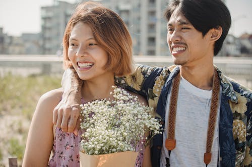 Free Man Resting his Arm Around Woman's Shoulder Stock Photo