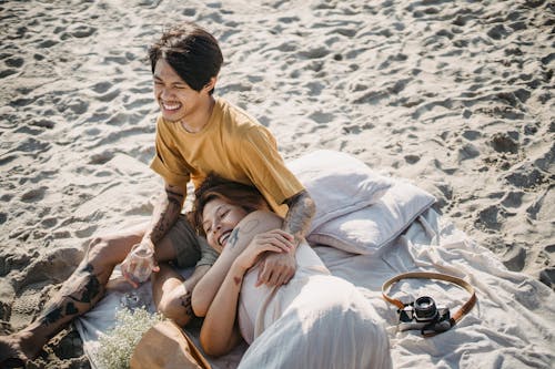 Man in Brown Crew Neck T-shirt with Woman in White Dress