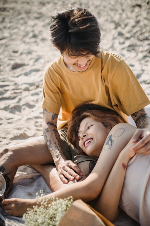 Man in Yellow Crew Neck T-shirt Looking at Woman