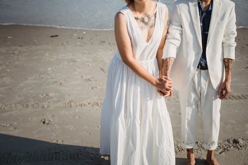 Woman in White Sleeveless Dress Standing on Beach