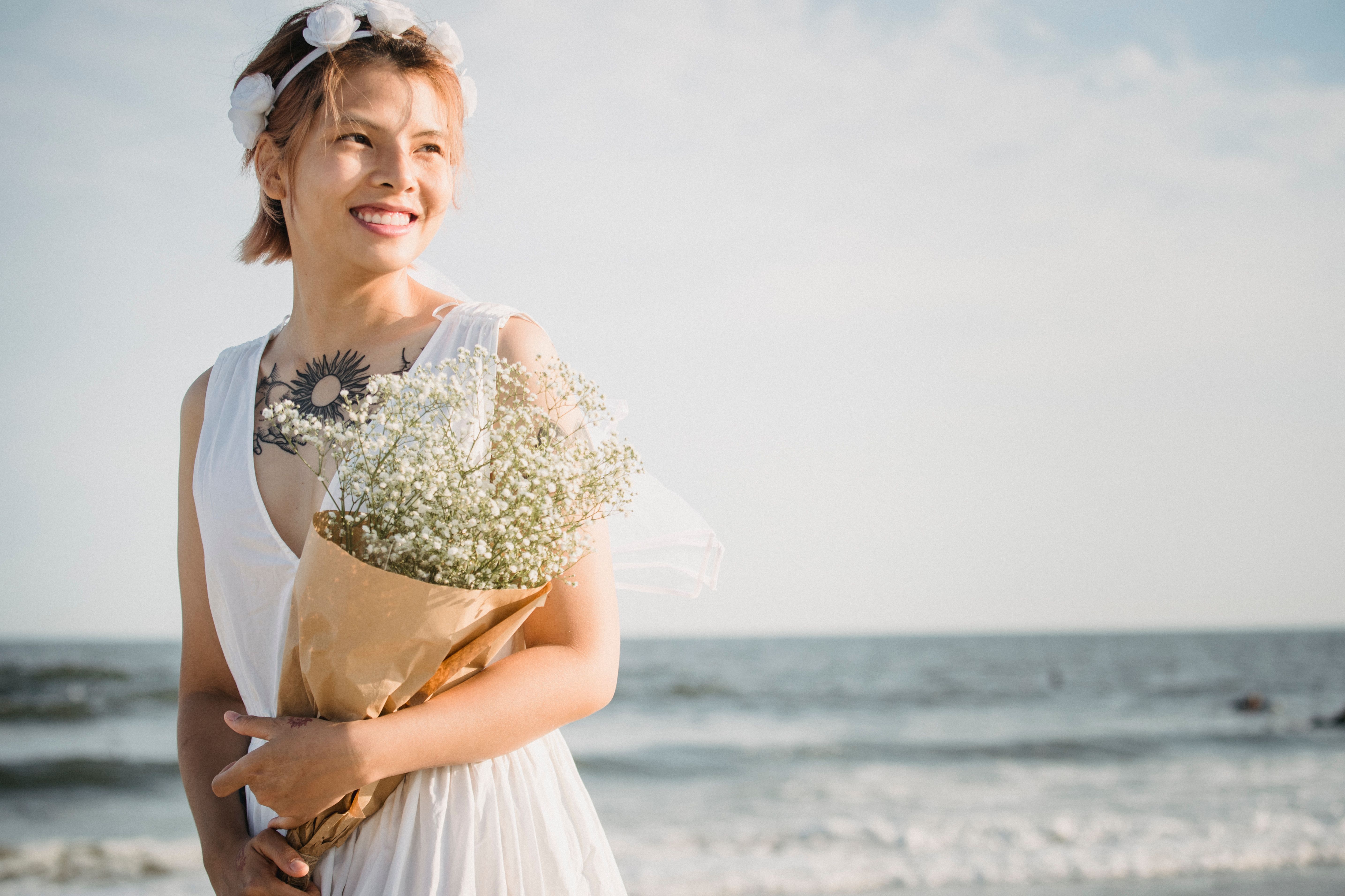 Woman in White Dress Holding Bouquet of Flowers · Free Stock Photo