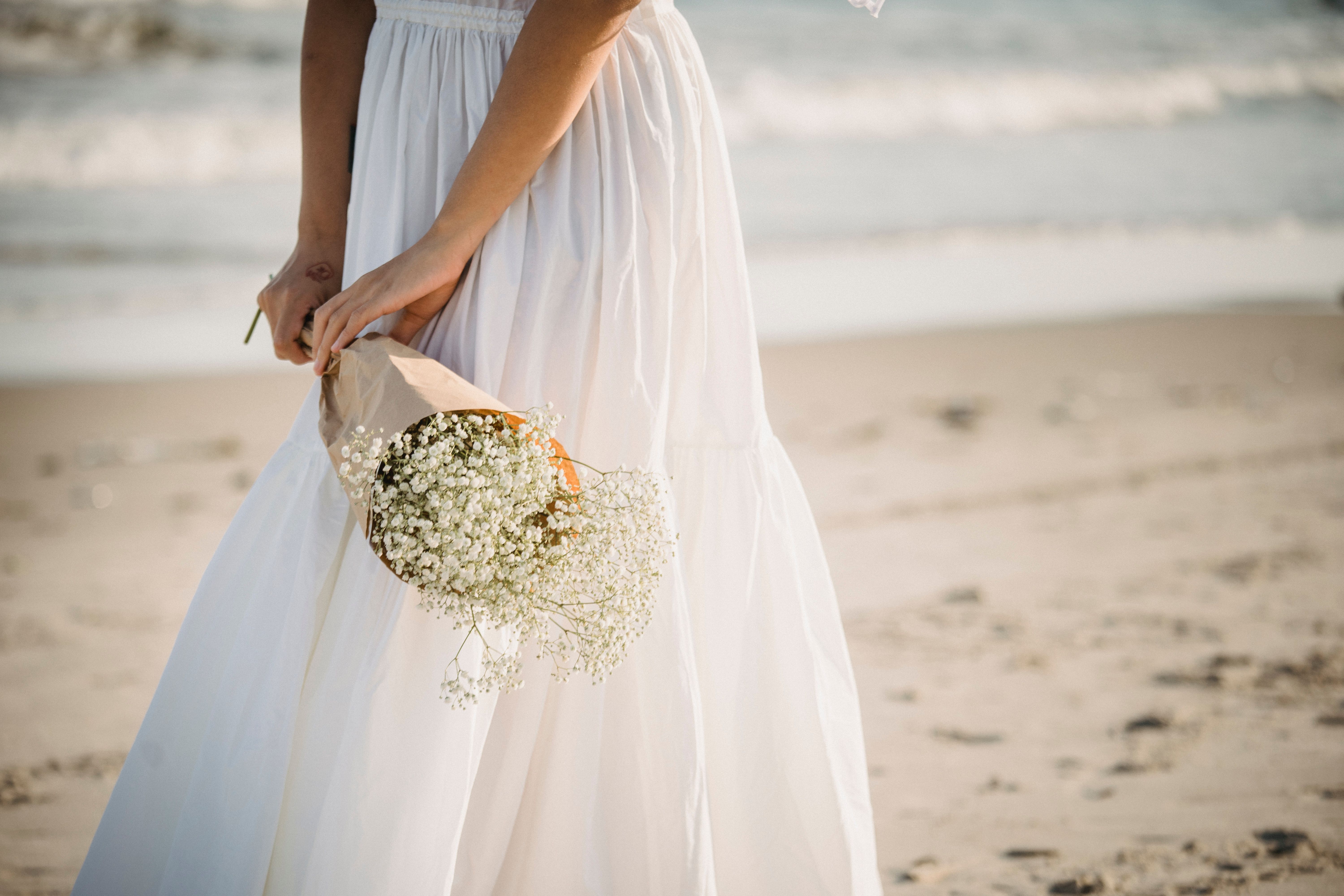 Woman in White Dress Holding Bouquet of Flowers · Free Stock Photo