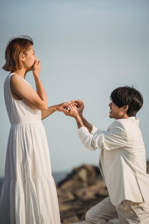 Man in White Suit Proposing to a Woman