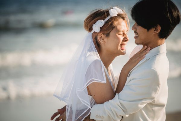 Newlyweds celebrating with friends on the sand