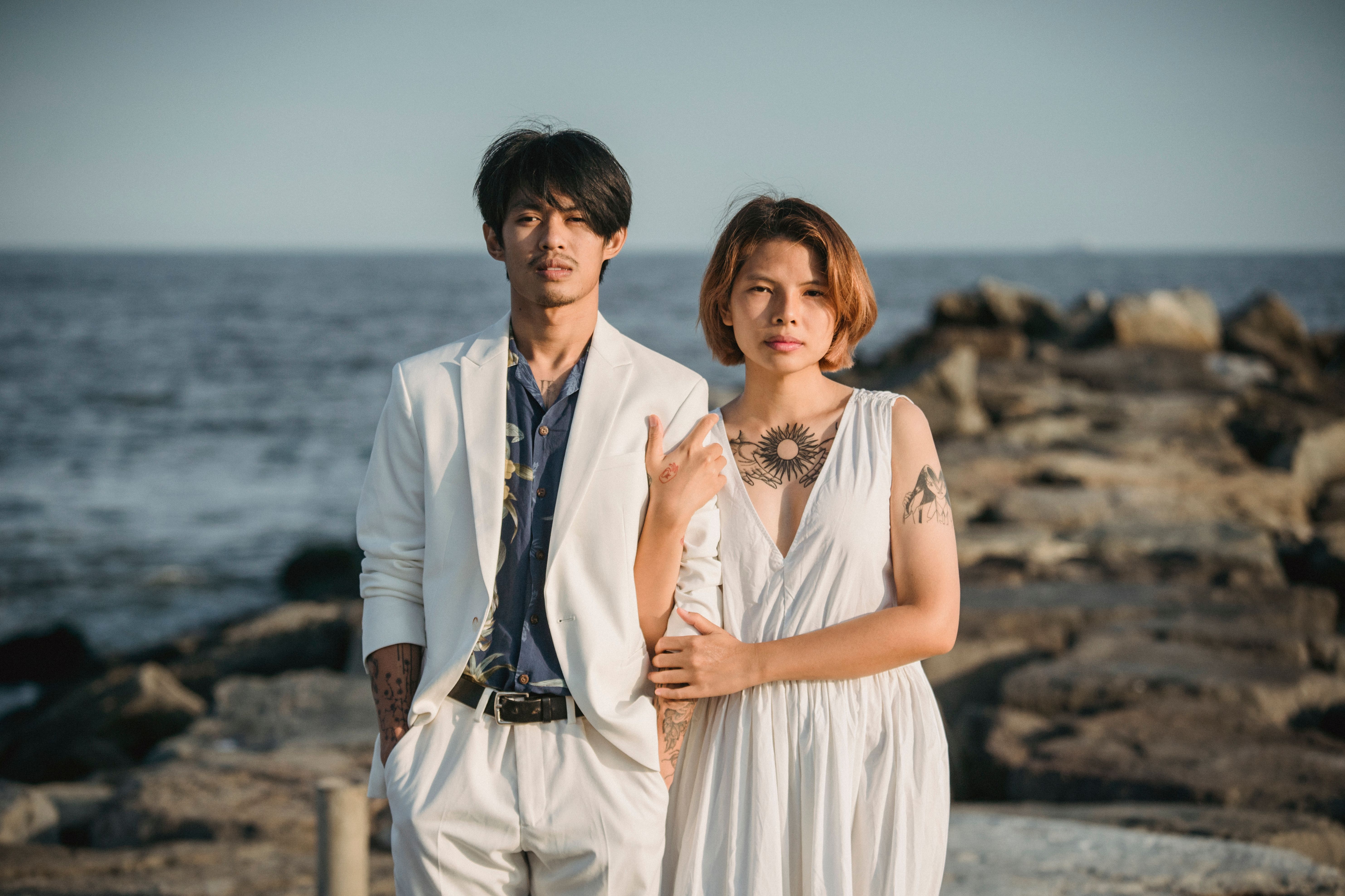 Fashionable couple displaying subtle minimalist temporary tattoos on their ankles together