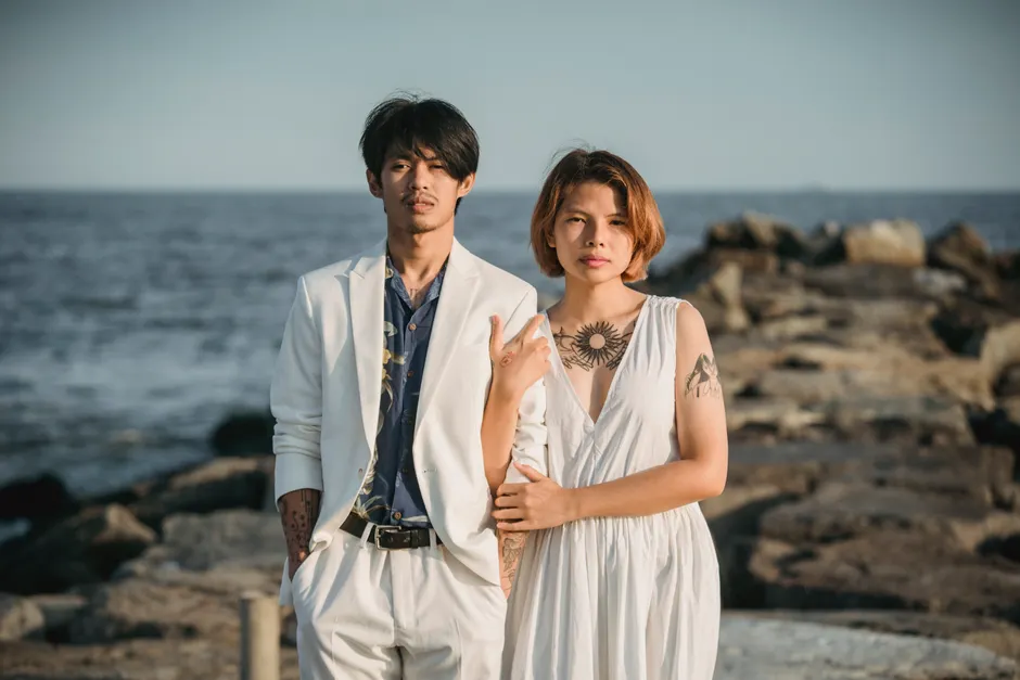 Fashionable couple displaying subtle minimalist temporary tattoos on their ankles together