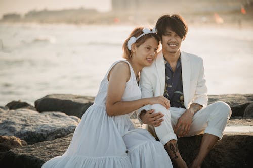 Free Man in White Suit Beside Woman in White Sleeveless  Stock Photo