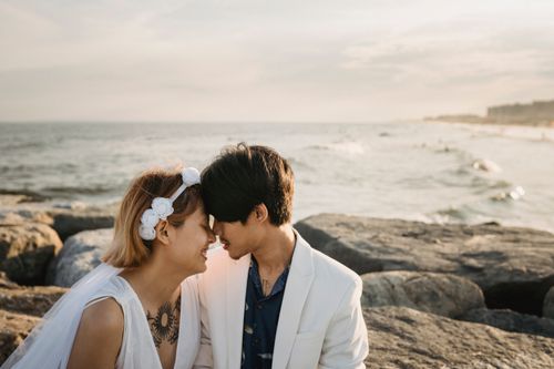Free A loving, romantic couple enjoys a serene moment by the sea during their beach wedding. Stock Photo