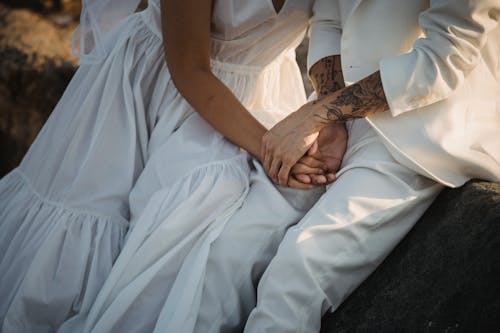 Couple Holding Hands While Sitting