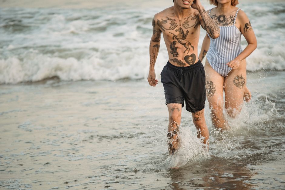Tourist considering a vacation tattoo at a small beach town studio Tourist considering a vacation tattoo at a small beach town studio