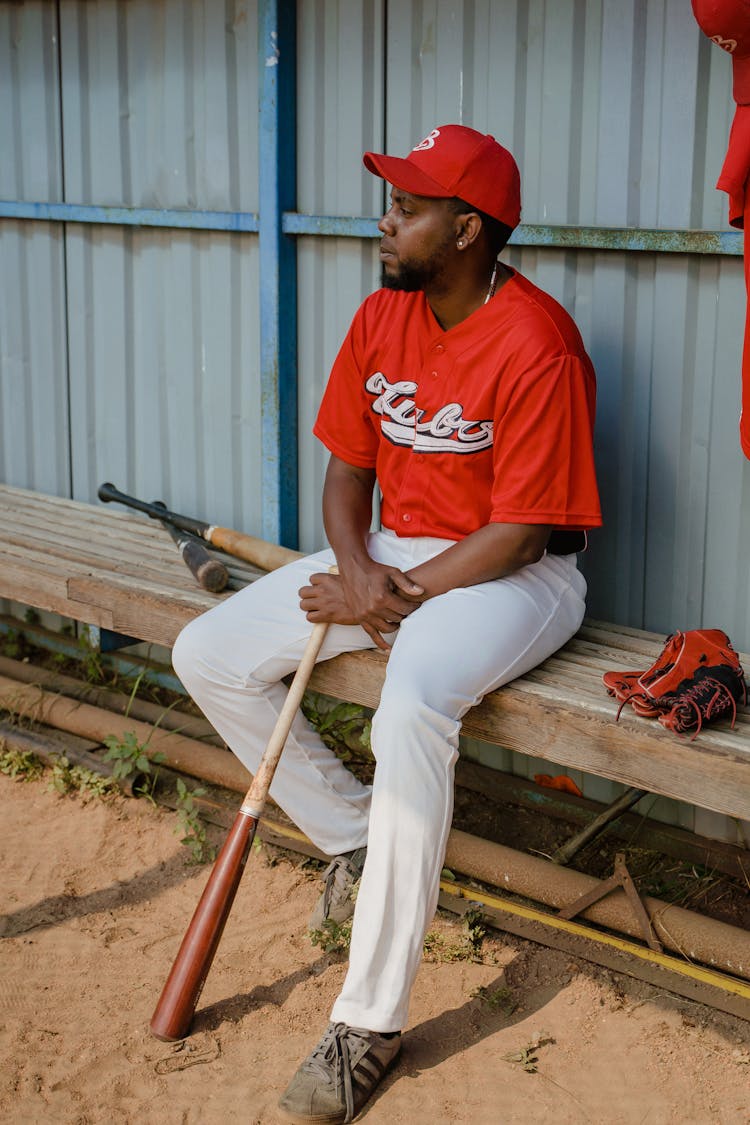 Baseball Player Sitting On A Bench