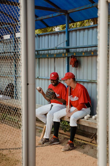 Men Wearing Red Baseball Jerseys and White Pants Sitting on a Bench · Free  Stock Photo