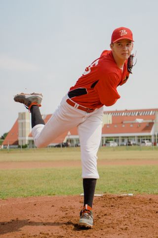 Pitcher mid-throw on a dirt mound — photo by Tima Miroshnichenko on Pexels