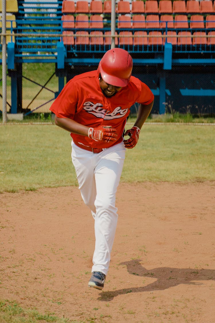 Man In Red Shirt And White Pants Playing Baseball