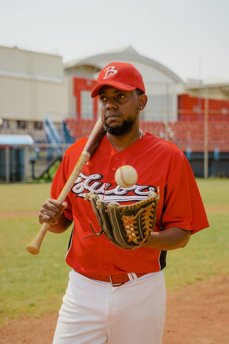 Man In Red Shirt Holding Baseball Bat