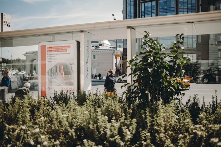 People Waiting On Modern Bus Stop