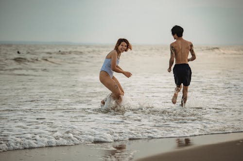 Free Man and Woman Having Fun at the Beach Stock Photo