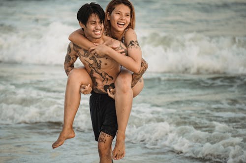 Free Man Carrying Woman on his Back Stock Photo