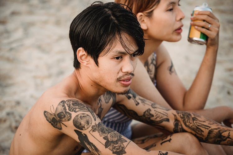 People In Tattoos Relaxing On Beach