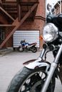 Black and Gray Motorcycle Parked Beside Brown Brick Wall