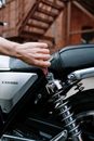 Person Holding Black and Silver Motorcycle