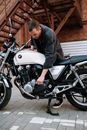 Man in Black Jacket Riding on White and Black Motorcycle