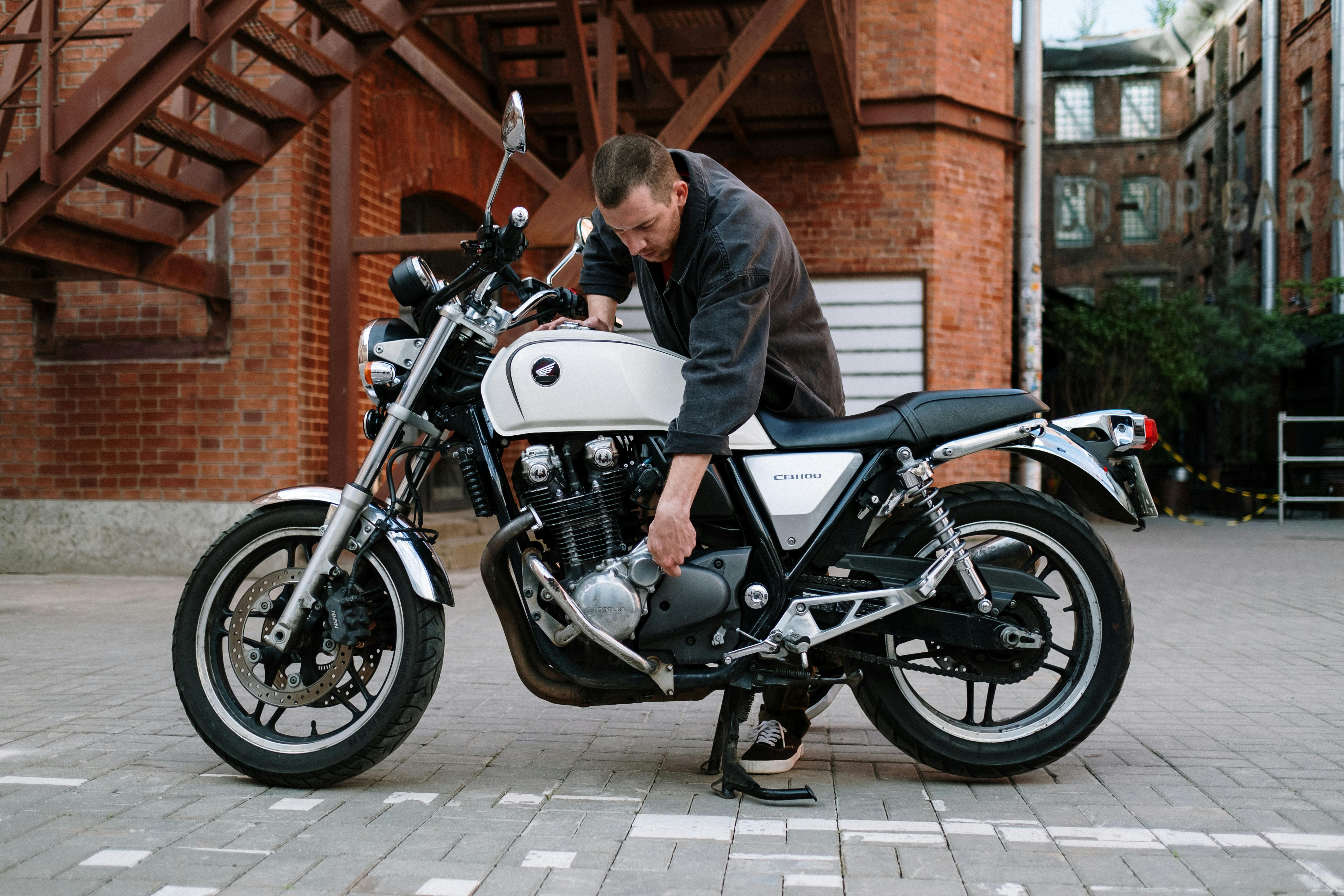 a man inspecting a motorcycle