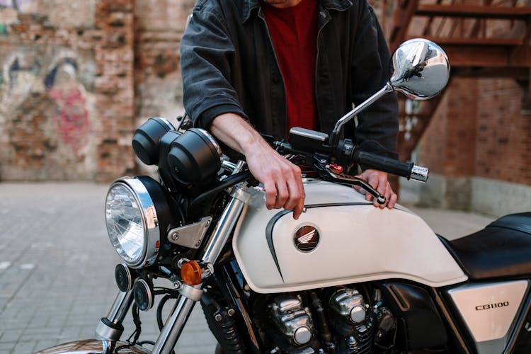 Man In Black Jacket Fixing Motorcycle