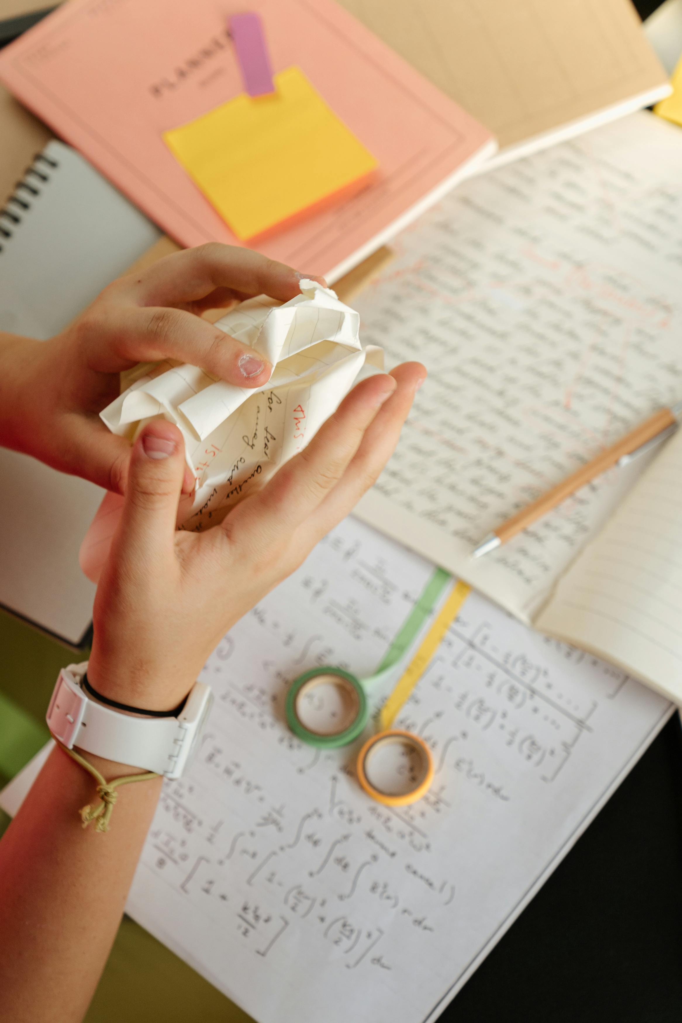 person holding crumpled white paper