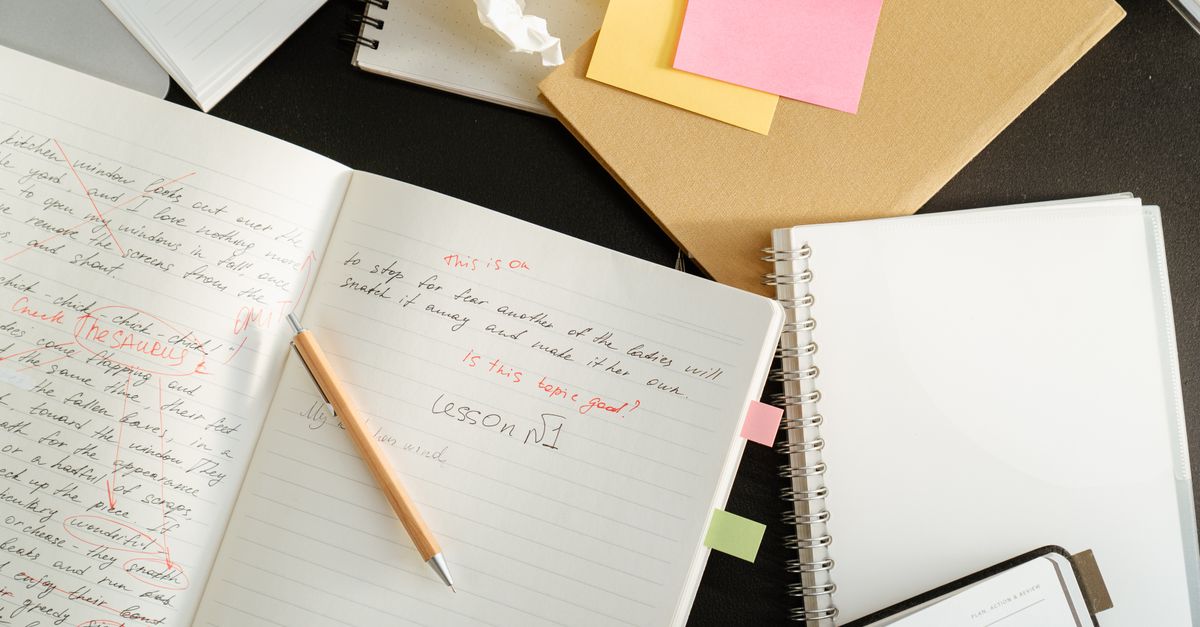 handwritten lyrics on crumpled notebook paper with coffee stain