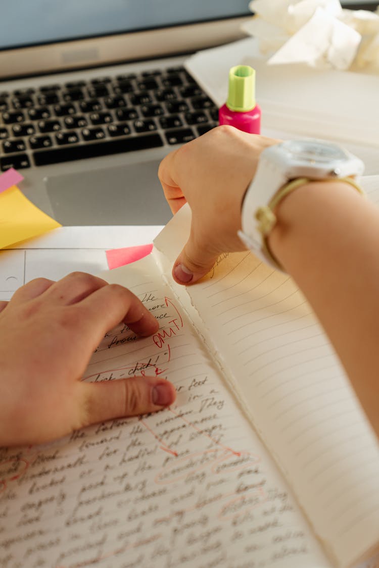 Person Tearing Of A Page In A Notebook