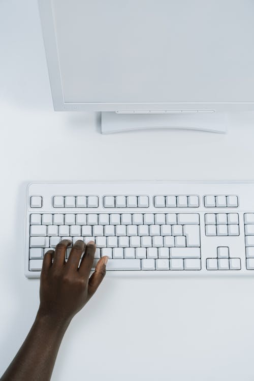 Person Holding White Computer Keyboard