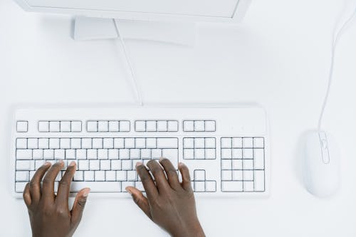 Free Hands Typing on White Keyboard  Stock Photo