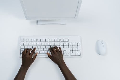 Free Person Using White Computer Keyboard Stock Photo