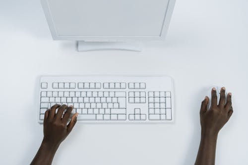 Free Person Using a White Computer Set Stock Photo