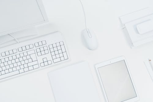 White Tablet and Computer Set of a Desk