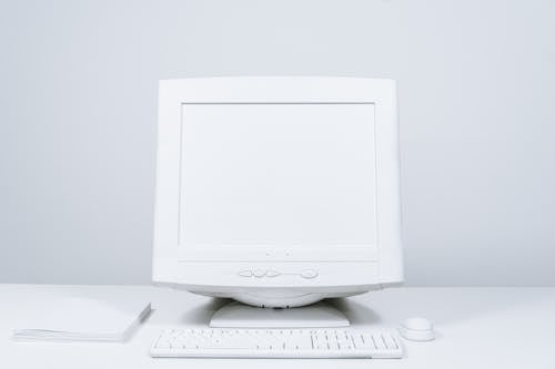 White Computer and Blank Screen Monitor