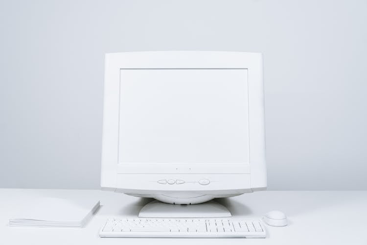 White Computer And Blank Screen Monitor