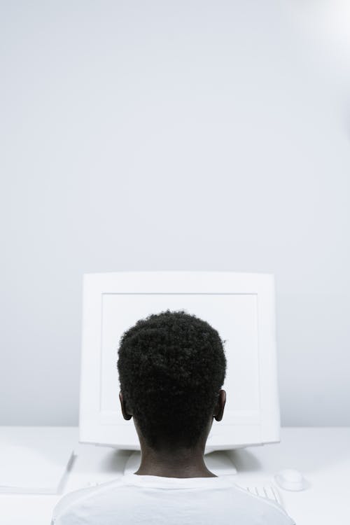 Person with Afro Hair Using a Computer