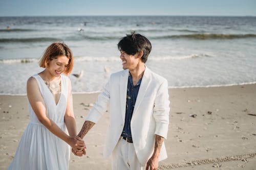 Couple Holding Hands on the Beach