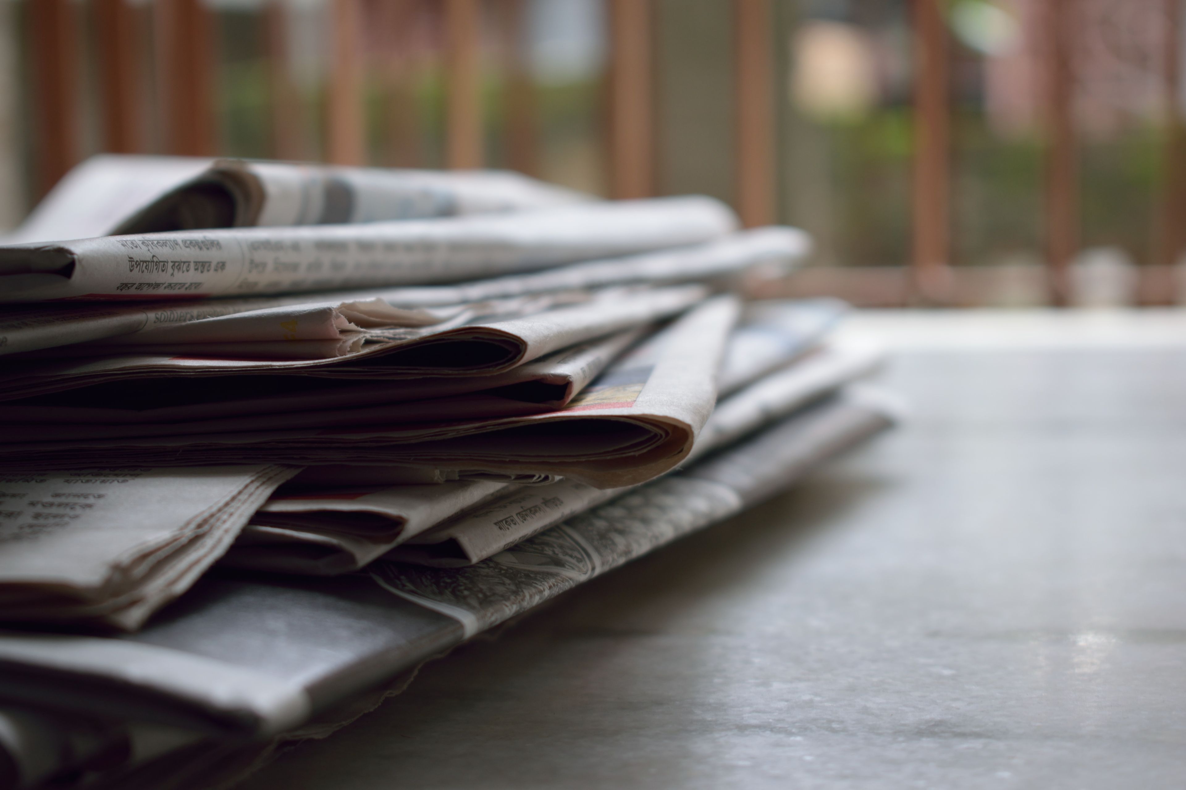 A stack of folded back issues of a newspaper