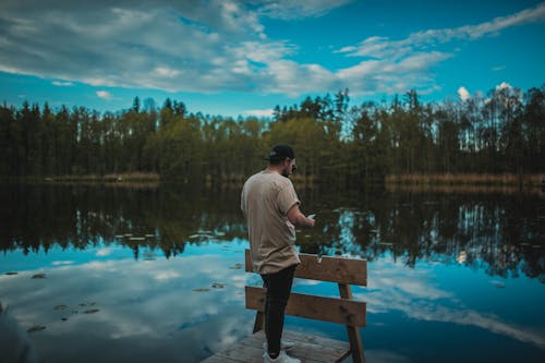 Free Man Standing on a Dock Stock Photo